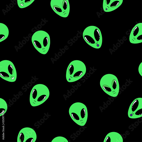 Vector illustration. Cute seamless pattern with green alien faces with different emotions isolated on black. Hand drawn doodle clipart. Space theme. Ideal for textile, poster, banner, gift wrapping.