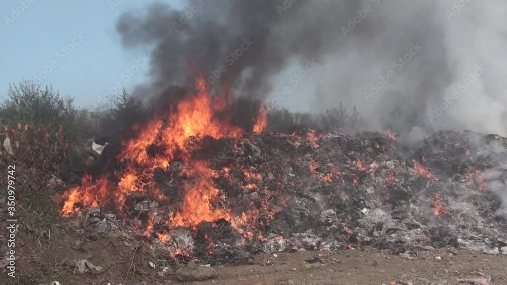 Fire, landfill fire, burning garbage, thick smoke rising, close-up shot of a burning fire, ecological accident, air pollution Fire, landfill fire, burning garbage, thick smoke rising, close-up shot of a burning fire, ecological accident, air pollution