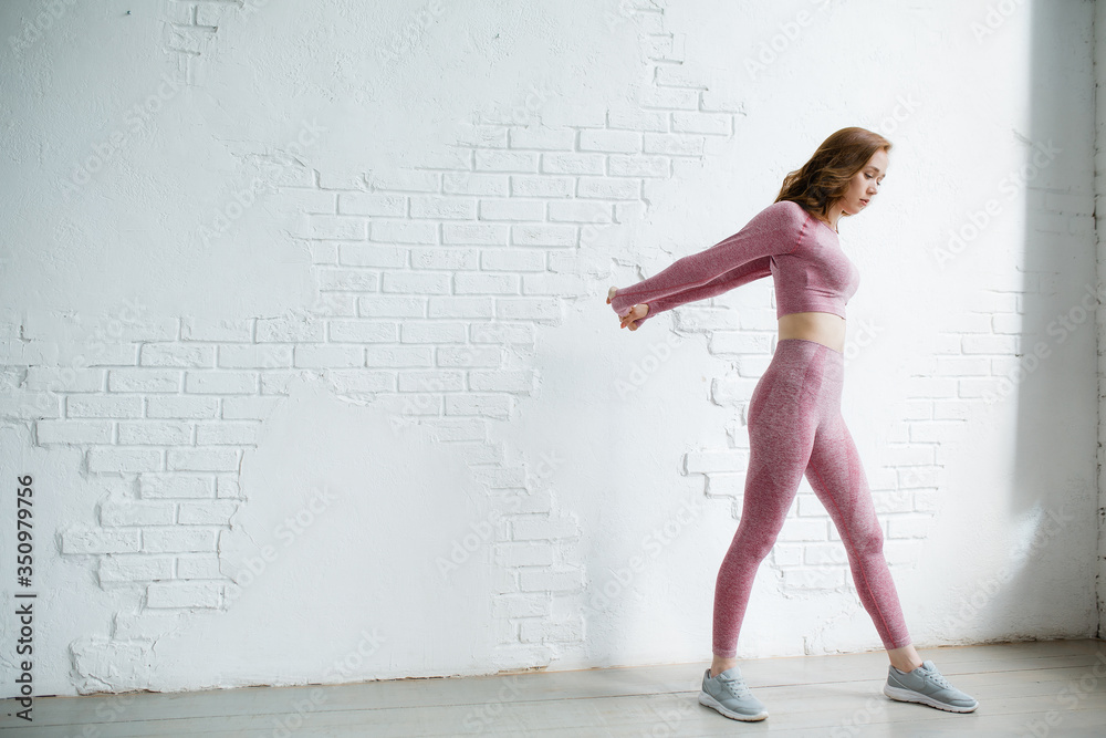 Ταπετσαρία A sports trainer does exercises while standing with his arms outstretched behind