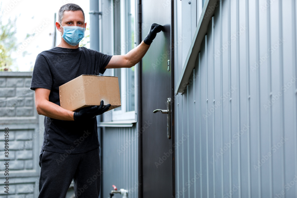 Home delivery shopping box man wearing gloves and protective mask delivering packages at door. Home delivery shopping box man wearing gloves and protective mask delivering packages at door.