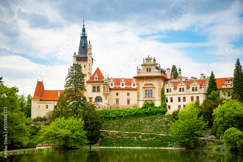 Castle with reflection in pond in spring time in Pruhonice, Czech Republic