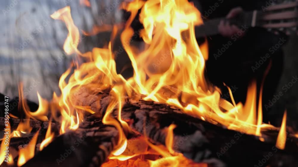 A bonfire burns. Close-up of flames. Summer evening. Slow motion. A bonfire burns. Close-up of flames. Summer evening. Slow motion.