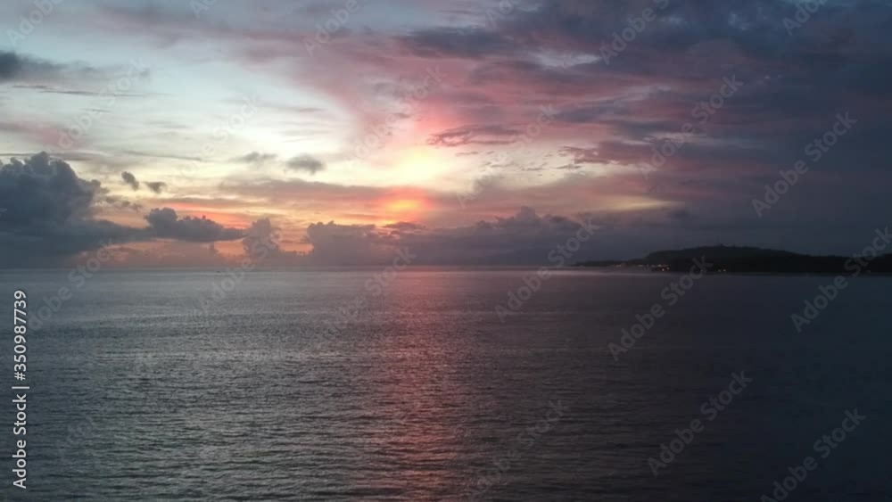 drone take off upwards with a view of a beautiful pink-blue sunset over the ocean drone take off upwards with a view of a beautiful pink-blue sunset over the ocean