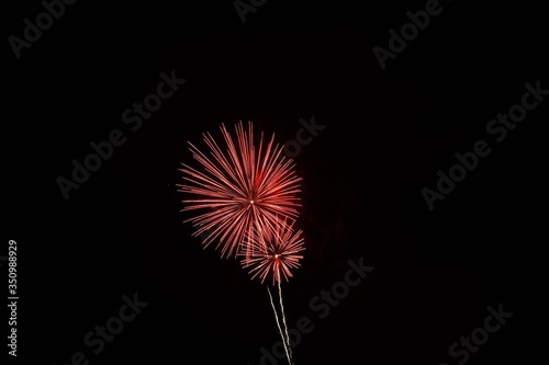 Red fireworks exploding in the night sky for a celebration