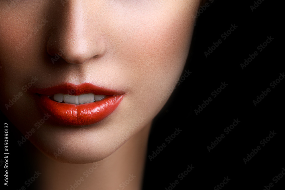 Obraz premium Close-up portrait of beautiful young woman lips with bright red lipstick
