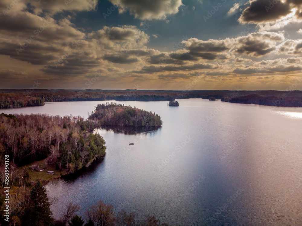 Fototapeta premium Northwoods Lake Sunset with fishing boat
