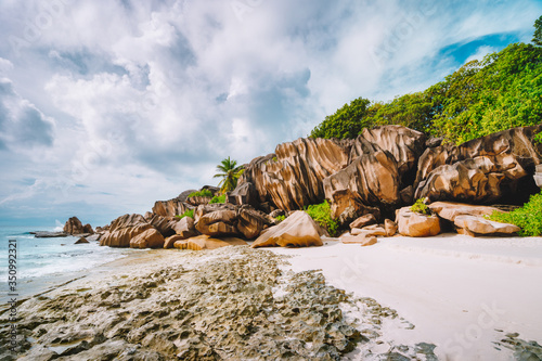 Grand Anse beach at La Digue island in Seychelles. Most famous granite rocks, white sandy beach, ocean lagoon and white clouds © Igor Tichonow