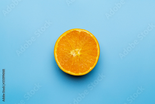 Slice of orange on blue background