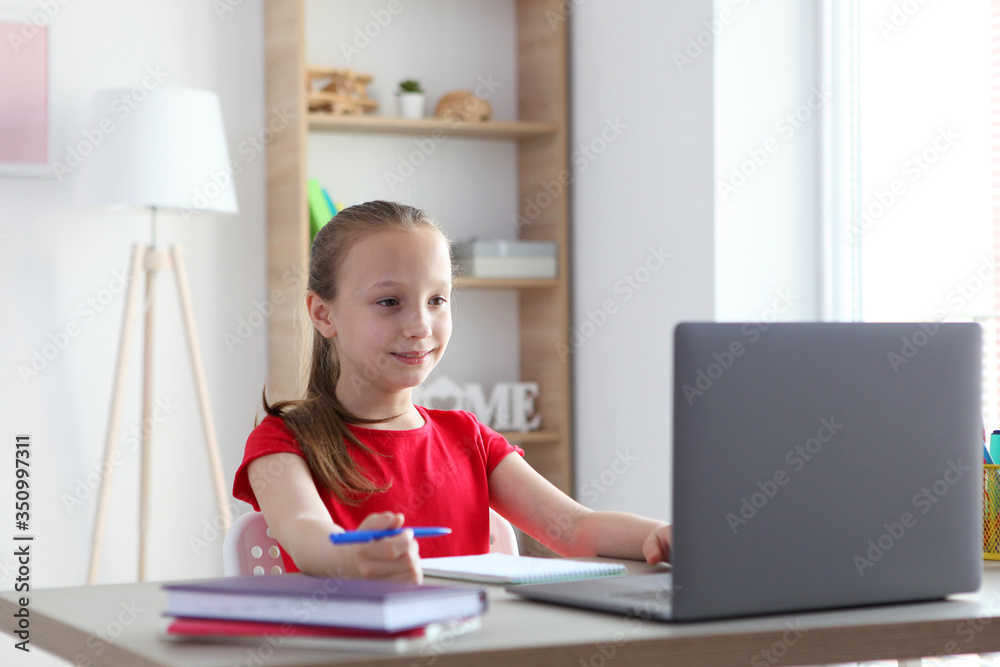 A child learns online at home through a modern laptop on the Internet.
A child learns online at home through a modern laptop on the Internet.