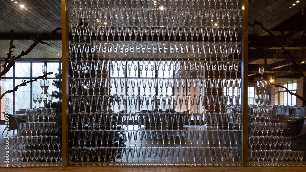 Wall of empty champagne glasses. Decorative element of restaurant interior. 