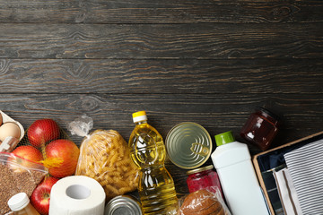 Different food on wooden background, top view. Donation concept