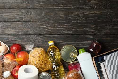 Different food on wooden background, top view. Donation concept