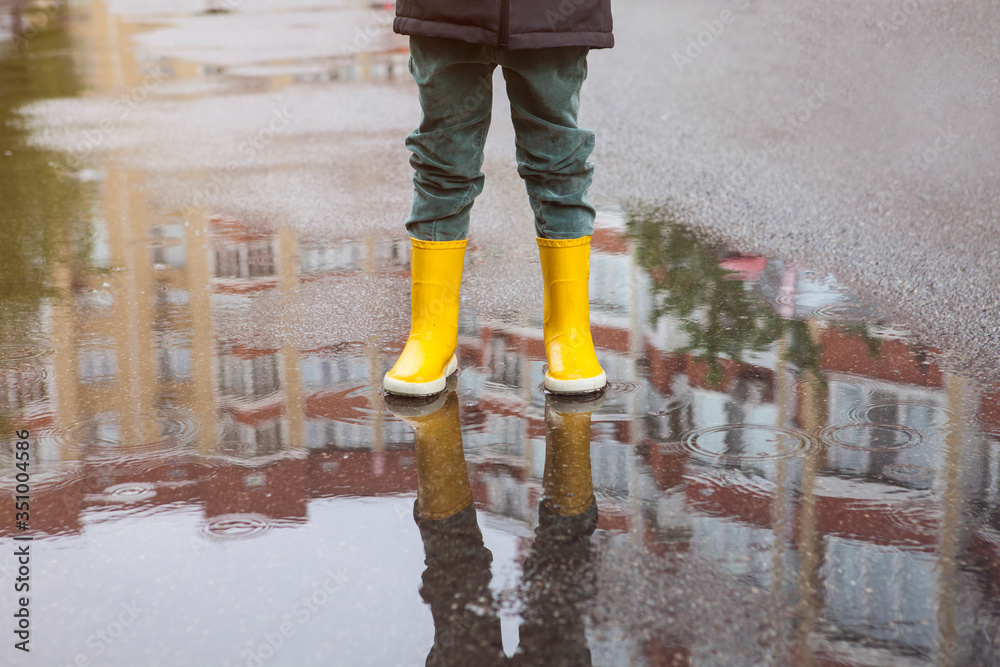 Boy in yellow boots in the rain Boy in yellow boots in the rain