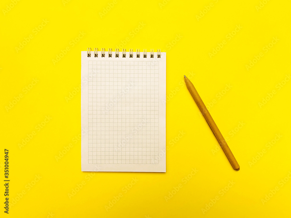 Notepad for writing on a yellow background Notepad for writing on a yellow background