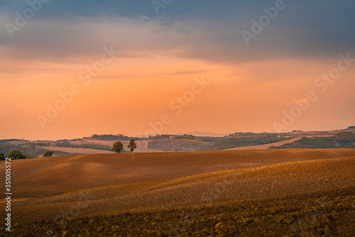 Beautiful warm toned sunset over Val d Orcia at pink hour. Tuscany  Italy