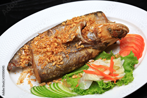 Ompok bimaculatus Fish Fried with crispy garlic photo