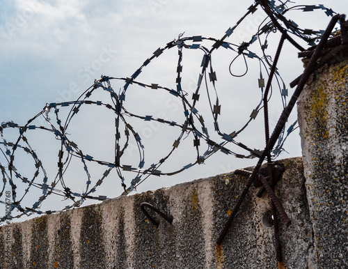 Concrete fence with barbed wire, barbed wire, fence, closed area, restricted area.