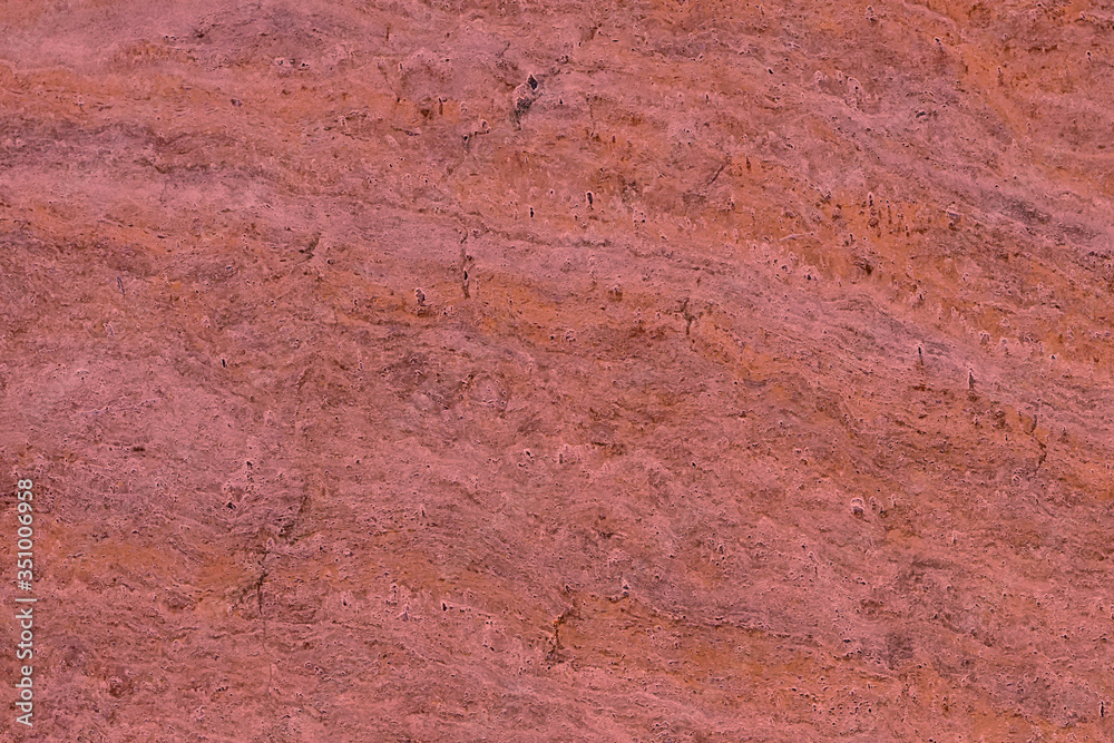 Red marble stone background pattern or texture. Onyx texture of natural stone. Surface of the marble with red tint.