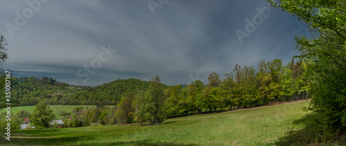 Green spring meadows near Dolni Becva village in Beskydy mountains photo