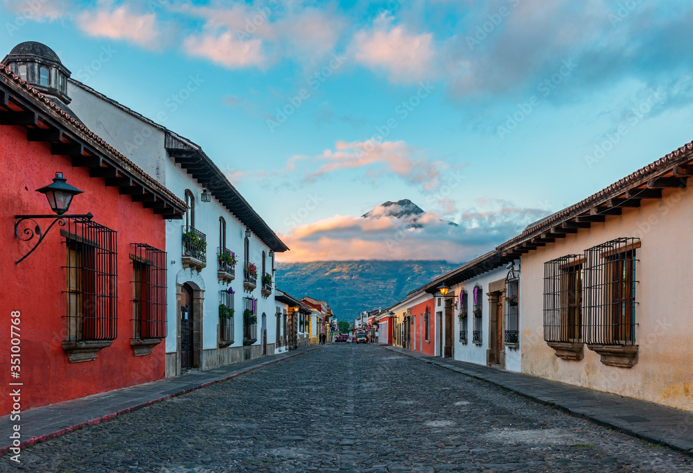 Sunrise in a colonial style street of Antigua City with the Agua volcano in the background, Guatemala.