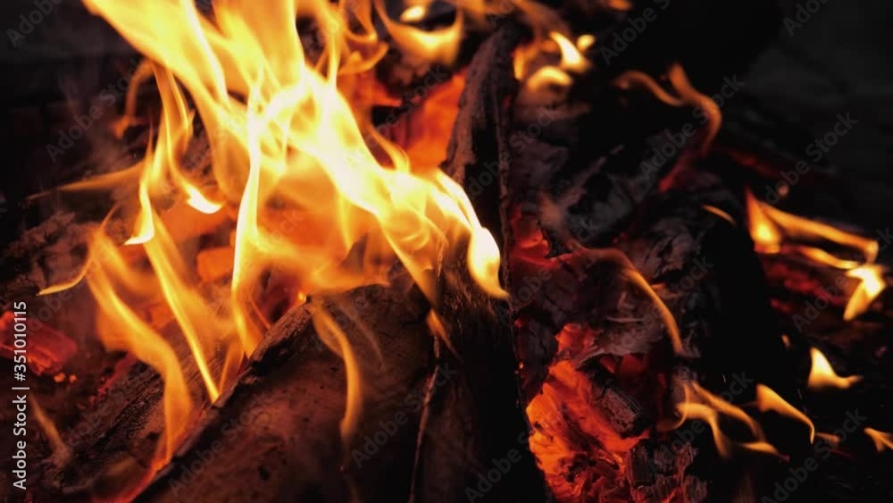 A bonfire burns. Close-up of flames. Summer evening. Slow motion. A bonfire burns. Close-up of flames. Summer evening. Slow motion.