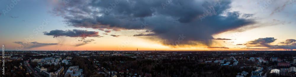 Panoramic aerial cloudy view of Helsinki city skyline at sunset.