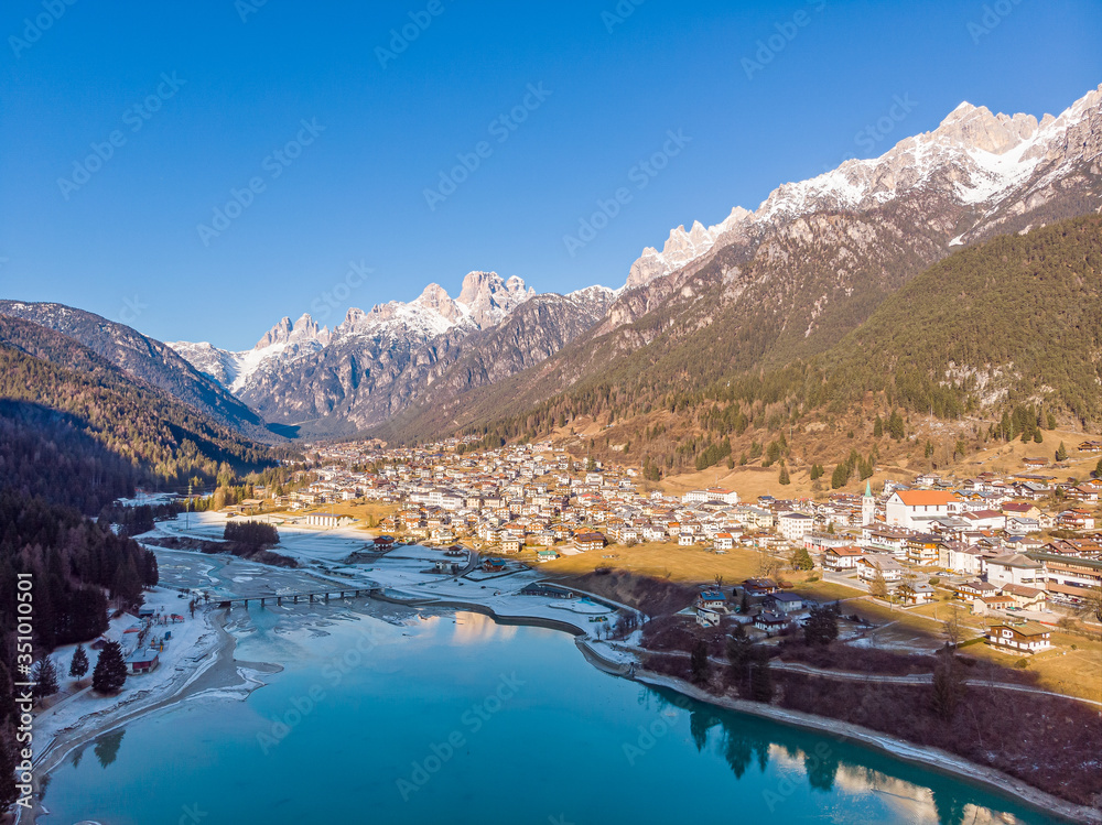 The view of Auronzo and the frozen lake Santa Katerina, Dolomites, Italy