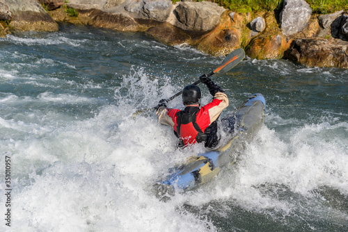man kayaking in whitewater river
