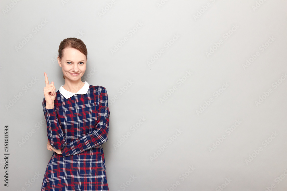 Portrait of happy girl pointing up with finger and smiling Portrait of happy girl pointing up with finger and smiling