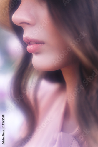 Graceful profile of woman with long hair. Soft focus.