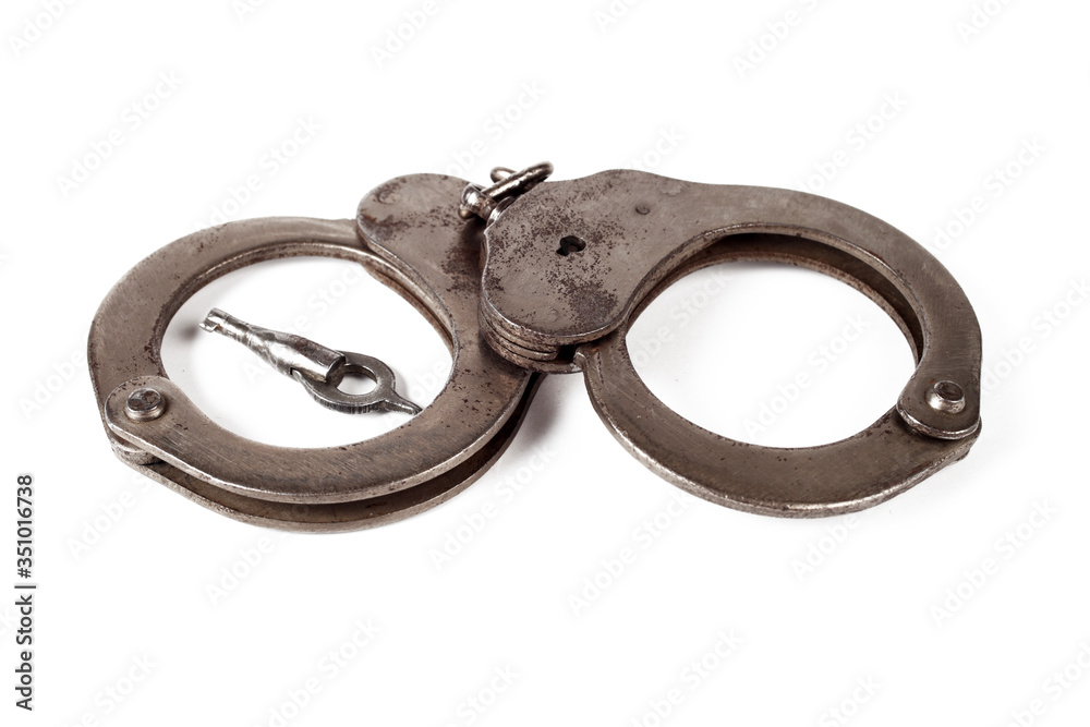 police handcuffs on a white background, isolate, close-up police handcuffs on a white background, isolate, close-up