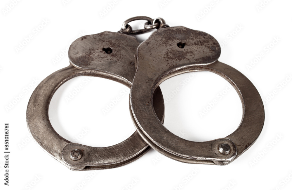 police handcuffs on a white background, isolate, close-up police handcuffs on a white background, isolate, close-up