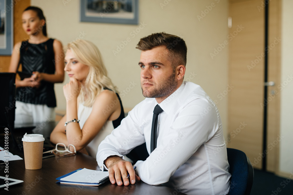 An employee sits during a meeting in the Business, Finance team An employee sits during a meeting in the Business, Finance team
