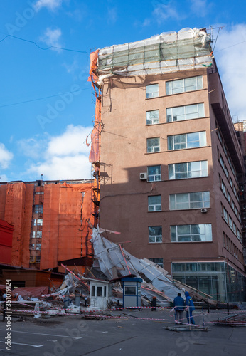 Scaffolding collapsed from a strong wind near a reconstructed multi-storey building in the city center.