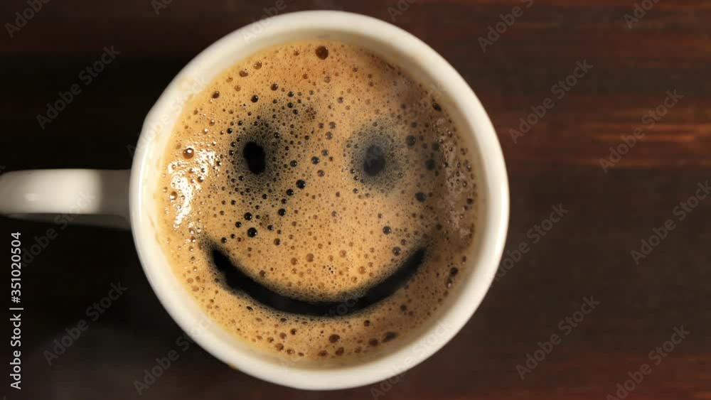 Good morning coffee smile cup on wooden background. Top view with smoke. Good morning coffee smile cup on wooden background. Top view with smoke.