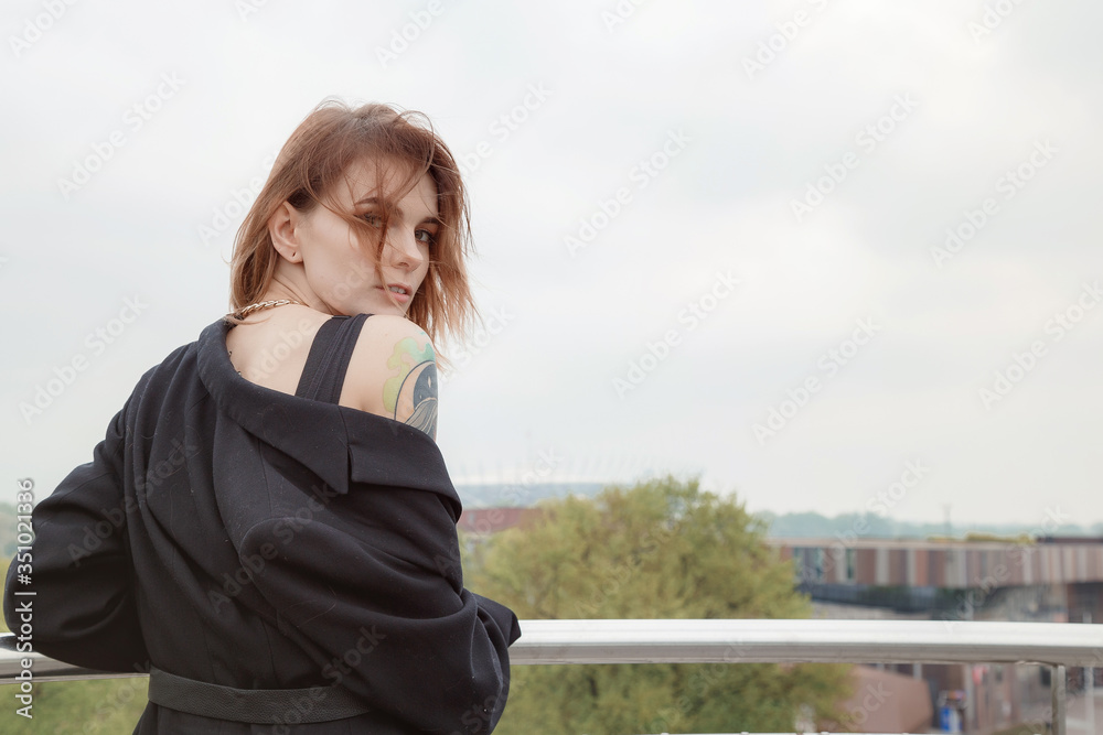 Girl on the balcony of the Warsaw University Library. Panorama of Świętokrzyski Bridge. Copernicus Science Center in Warsaw. Portrait of a pretty woman. Fashion.