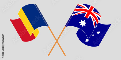Crossed and waving flags of Romania and Australia