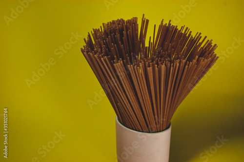 spaghetti on a yellow background