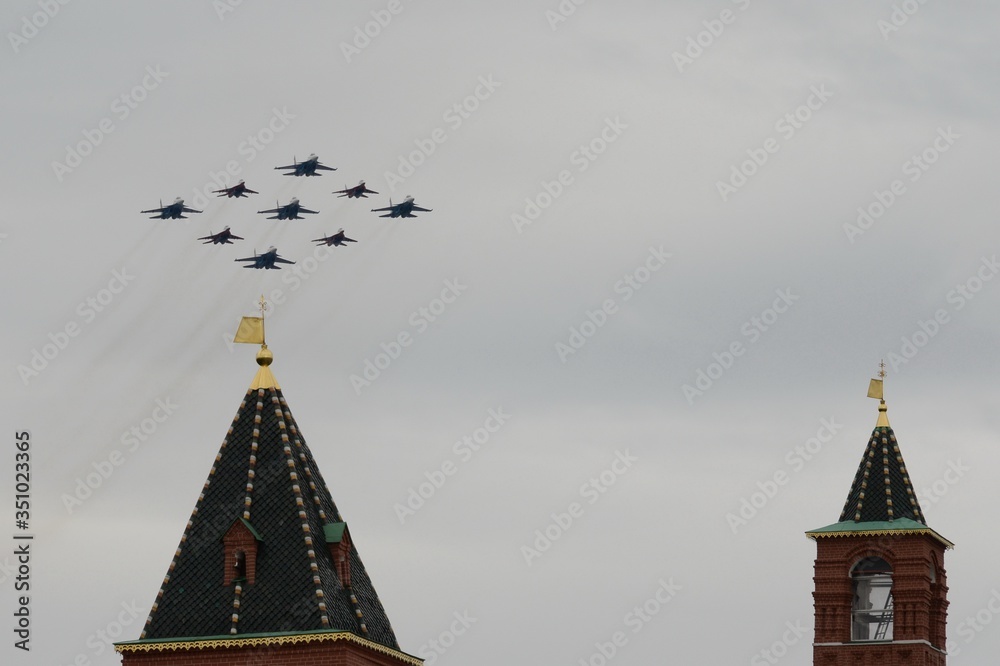 Fototapeta premium The Swifts and Russian Knights pilots on the Su-30 SM and MiG-29 planes fly over Red Square during the parade on Victory Day in World War II