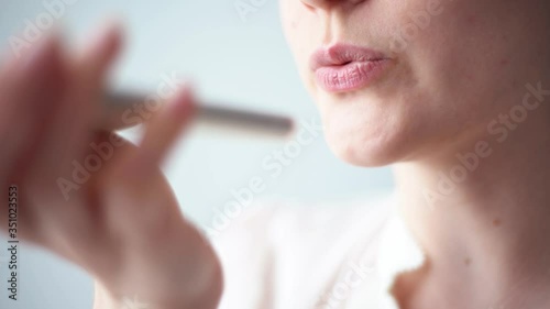 Close-up voice control of a smart home on a mobile phone. Talking mouth in the speaker of a young woman