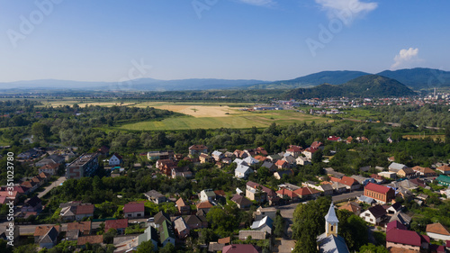 Mountain panorama of Mukachevo - view from the drone. Beautiful spring and summer landscape of a small town in Transcarpathia (Ukraine)