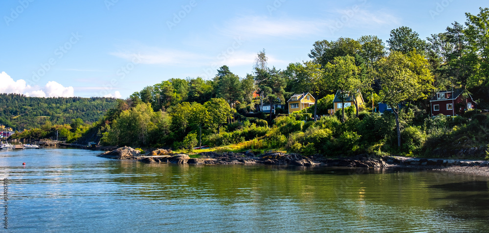 Naklejka premium Panoramic view of Lindoya island on Oslofjord harbor near Oslo, Norway, with Lindoya Ost marina and summer cabin houses at shoreline in early autumn
