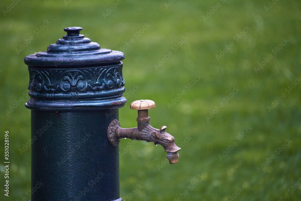 Close-up of old-style column with drinking water in public park, selective focus Close-up of old-style column with drinking water in public park, selective focus