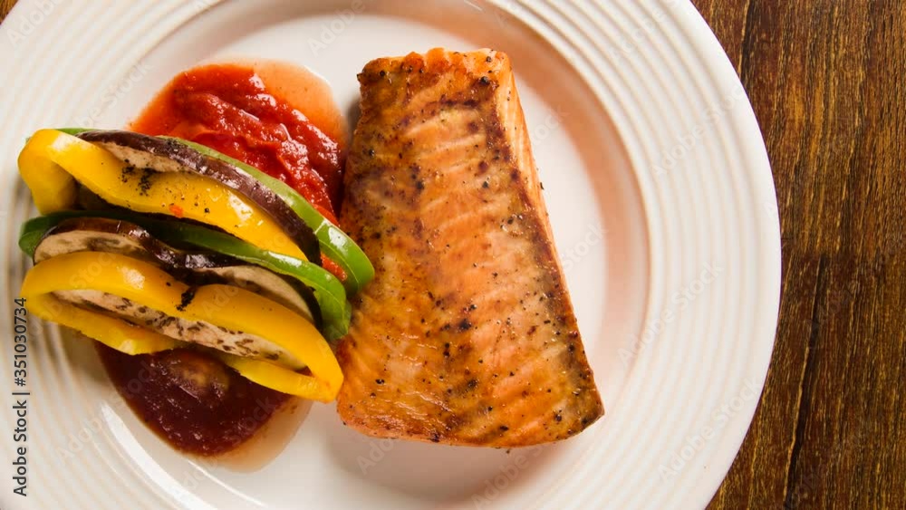 Salmon fillet with mixed vegetables. Top view with smoke. Salmon fillet with mixed vegetables. Top view with smoke.