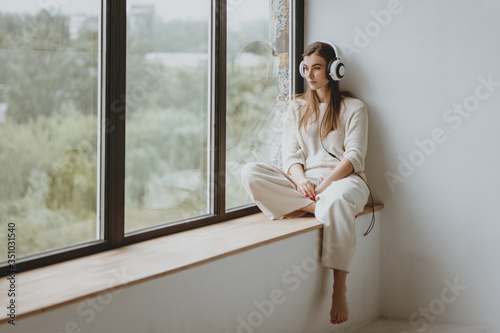 Woman listening music in headphones.