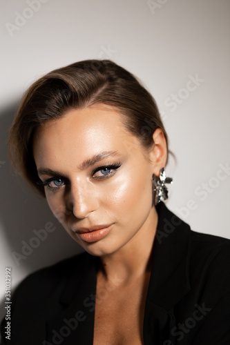 Portrait of a beautiful woman with makeup and styling. Blue eyes, fashionable eyebrows and beautiful lips.