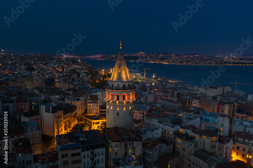Galata Tower night aerial with Bosphorus Bridge on the background