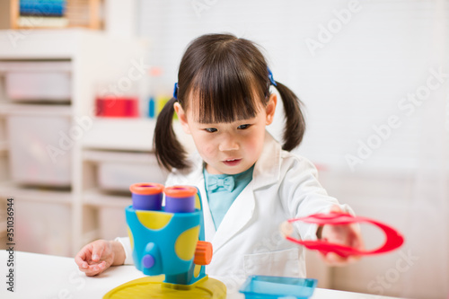 toddler girl pretend play scientist role for homeschooling