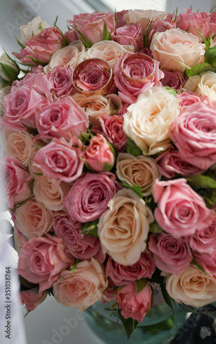 Bouquet of red and white roses and rings on flowers. Wedding day romantic.