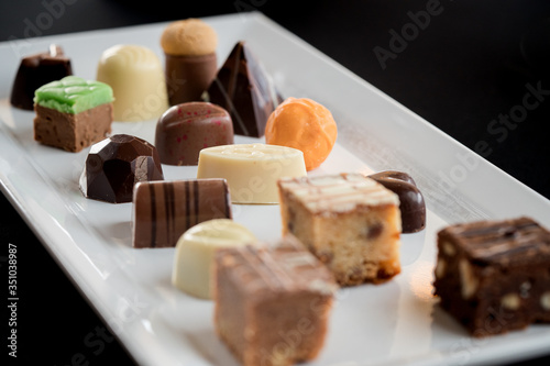 Beautiful Cceative chocolate sweets on white plate